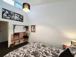 a bedroom with a bed and a bench on the wall at Modern 3 bedroom apartment, beach, surf & shops in Cape Woolamai