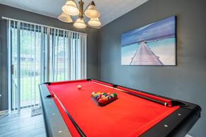 a red pool table in a room with avertisementbestosbestosbestosbestosbestosbestos at Amazing and Beautiful Home in Atlanta in Atlanta