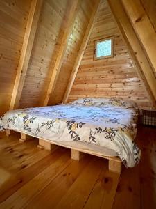 a bed in the attic of a log cabin at The view in Bijelo Polje
