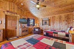 a bedroom with two beds and a ceiling fan at Trapper's Rendezvous in Williams