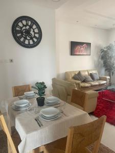 a living room with a table and a couch at Al Qalah flats 