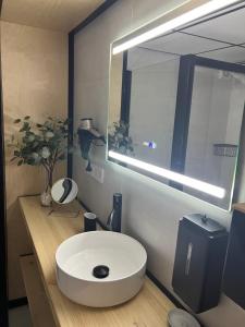 a bathroom with a white sink and a large mirror at PLAYALUZ in Aguadulce