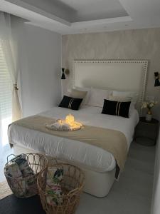 a bedroom with a large bed with two baskets at PLAYALUZ in Aguadulce