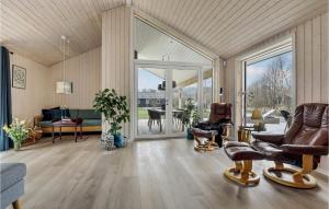 a living room with furniture and a large glass door at 3 Bedroom Nice Home In Aakirkeby in Vester Sømarken