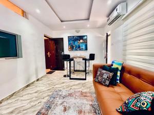 a living room with a couch and a table at The EDEN in Lagos