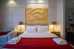 a bedroom with a bed with a red blanket at Hotel Atina in Budva