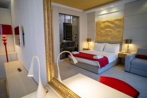 a hotel room with a bed and a mirror at Hotel Atina in Budva
