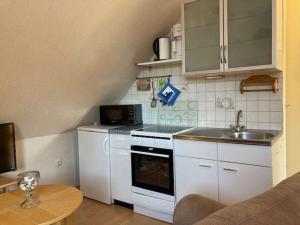 a small kitchen with a sink and a stove at Wohnung-Ley in Dahme