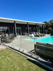 a building with a swimming pool and a building with a swimming pool at Titoki Grove in Cambridge