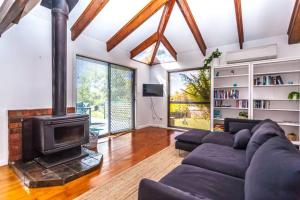 a living room with a couch and a fireplace at Beach Haven Scamander in Scamander