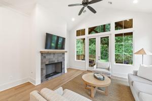 a living room with a couch and a fireplace at New 3BR Cottage with King Bed in Lafayette