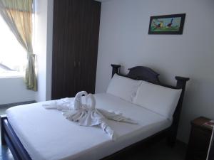 מיטה או מיטות בחדר ב-Hotel Orinoquia Real