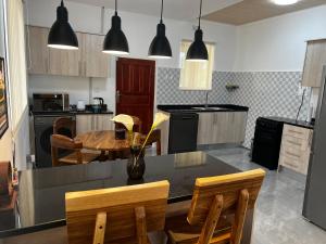 a kitchen with a table and chairs and a dining room at Smart Stay Eco Friendly AirBnB in Lusaka