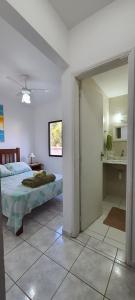 a bedroom with a bed and a bathroom with a mirror at Cantinho do Boris l in Ubatuba