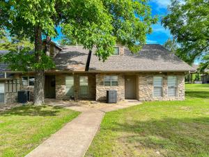 a stone house with a tree and a sidewalk at 3BR Walk-In with Loft - Pool and Hot Tub - FREE ATTRACTION TICKETS INCLUDED - PARA in Branson