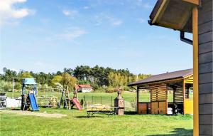 a park with a picnic table and a playground at Gorgeous Home In Smoldzino in Smołdzino