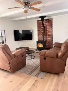 a living room with two couches and a fireplace at House w Patio & Fenced Yard 10 minutes to Purdue in Lafayette