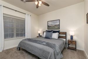 a bedroom with a bed and a ceiling fan at 3BR Walk-In - Close to Attractions - FREE TICKETS each day you stay - RL4-2 in Branson