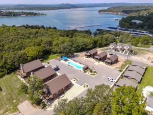 an aerial view of a resort with a pool and a lake at 4BD Lodge at Table Rock Lake - Near Marina - Pool - FREE TICKETS INCLUDED - BBH in Lampe