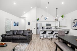 a living room with a couch and a kitchen at 4BD Lodge at Table Rock Lake - Near Marina - Pool - BBH in Lampe