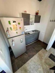 a kitchen with a refrigerator with magnets on it at Acogedor apartamento en conjunto residencial in Soledad