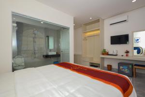 a bedroom with a large bed and a shower at Hai Duong PQ Hotel in Phu Quoc +54 photos