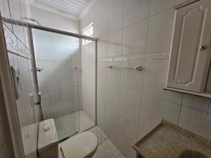 a bathroom with a shower with a toilet and a sink at Pousada 218 Manaus in Manaus