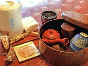 a tea kettle in a pot on a table at Kobori Ryokan in Hirosaki