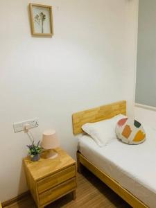 a bedroom with a bed and a table with a lamp at 森林城市 6999 Homestay【小温馨】@ 免税岛 Legoland JB SG in Gelang Patah