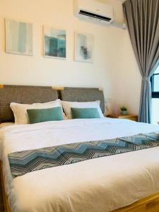 una camera da letto con un grande letto bianco e una finestra di 森林城市 6999 Homestay【小温馨】@ 免税岛 Legoland JB SG a Gelang Patah