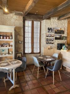 a restaurant with two tables and chairs in a room at Les Mirabelles in Tournon-dʼAgenais +3 photos