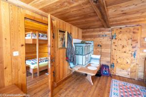 a log cabin with two bunk beds and a desk at Haus Zer Trächu in Saas-Almagell