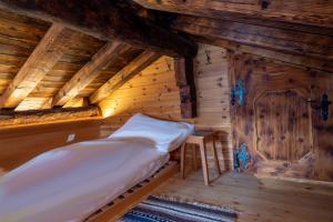 a bedroom with a bed in a wooden cabin at Haus Zer Trächu in Saas-Almagell