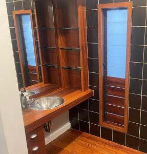 a bathroom with a sink and a mirror at CBD Apartment, River View in Hamilton