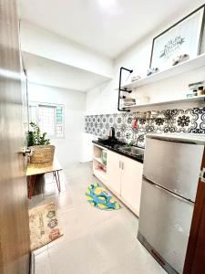 a kitchen with a refrigerator and a counter top at Duplex WARM HANOI, 2 bedrooms, Old Quarter, 3mins to Hoan Kiem Lake in Hanoi