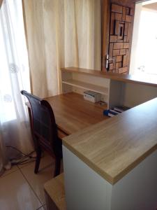 a desk with a chair and a wooden table at Antique Home BnB in Gaborone