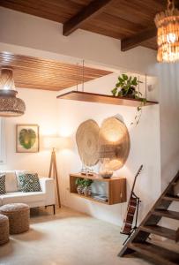 a living room with a couch and a table at Casa Kala "Uma experiência beira-mar" in Porto De Galinhas