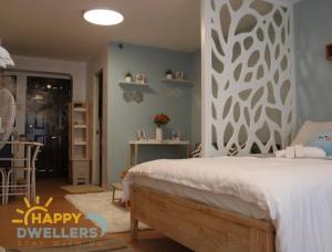 a bedroom with a bed with a happy dividends wall at Happy Dwellers in Marilao