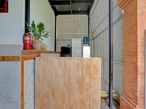 a room with a counter and a refrigerator at Tiny House Gianyar in Gianyar