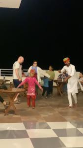 a group of people standing around a picnic table at Hotel Saif Ranthambhore in Sawāi Mādhopur