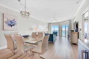 a dining room and living room with a table and chairs at Emerald Isle Unit 703 in Pensacola Beach