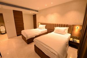 Postel nebo postele na pokoji v ubytování HOTEL ANUPAM RESIDENCY