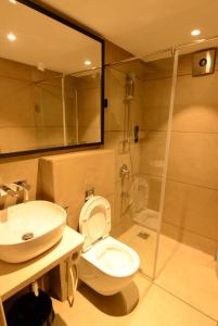 a bathroom with a toilet and a sink and a shower at HOTEL ANUPAM RESIDENCY in Mumbai