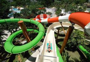 a ride in a roller coaster at a theme park at 5 Min Walk To Famous Blue Water Resort And Tourist Area in Maribago