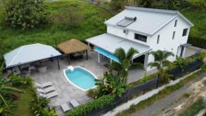 una vista aérea de una casa con piscina en villa Lorenza, en Petit-Bourg