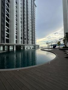 a large building with a pool in front of a building at Sea View The Shore Luxury Newly Renovated Homestay in Kota Kinabalu