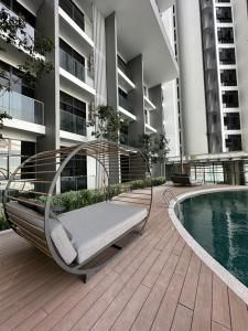 a bench sitting on a deck next to a swimming pool at Sea View The Shore Luxury Newly Renovated Homestay in Kota Kinabalu