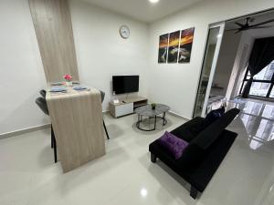 a living room with a couch and a tv at Sea View The Shore Luxury Newly Renovated Homestay in Kota Kinabalu