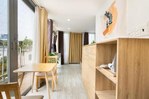 a kitchen with a table and a dining room at Ekomo Home 102 - Central Saigon in Ho Chi Minh City