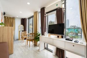 a room with a desk with a flat screen tv at Ekomo Home 102 - Central Saigon in Ho Chi Minh City